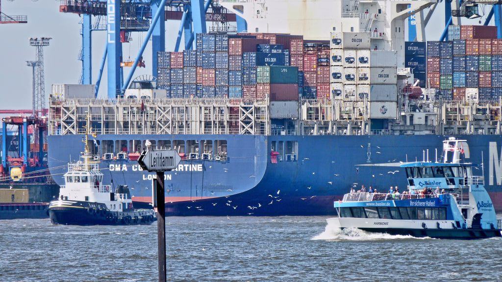 container ship with tug boat