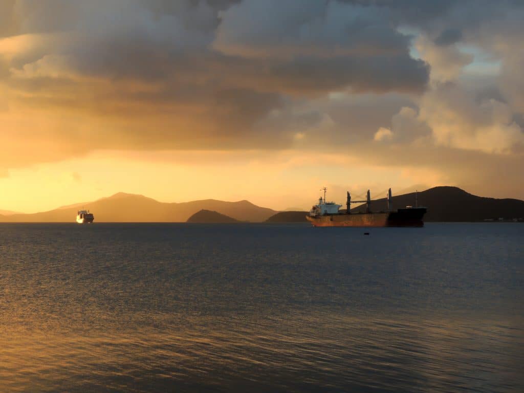 sunset at sea with 2 tankers in distance